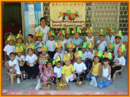 Nutrition+Month+Theme+2010+Philippines ... school kids studying or playing at the school with them is teacher ann